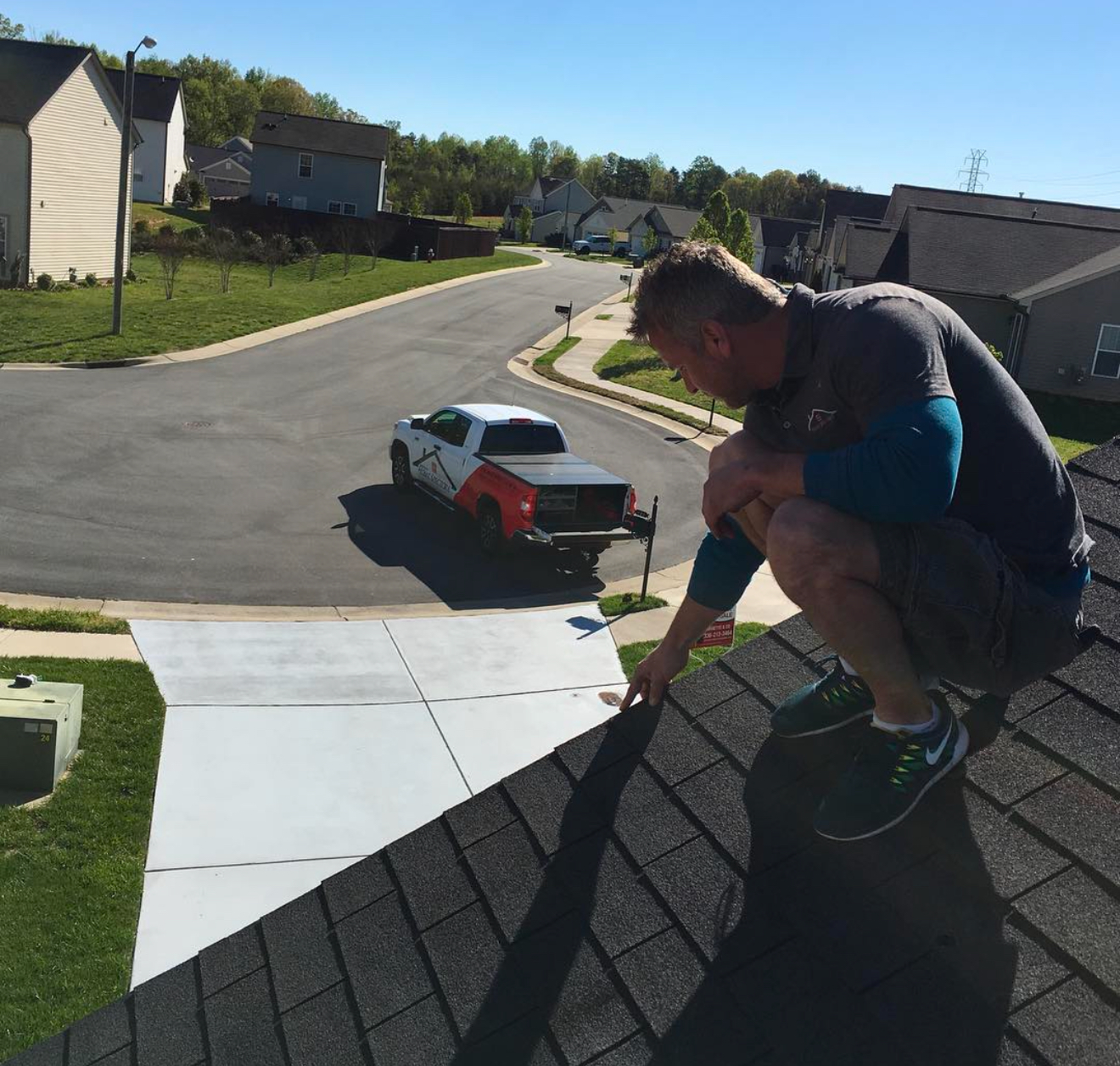 Home Spectors inspector checking a roof during a Greensboro home inspection.